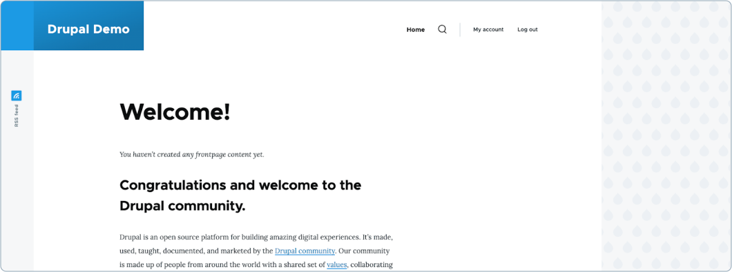 Screenshot of the default Drupal homepage with a ‘Welcome!’ message and text congratulating the user for joining the Drupal community. The page includes navigation options such as Home, My account, and Log out, with a sidebar showing an RSS feed icon.