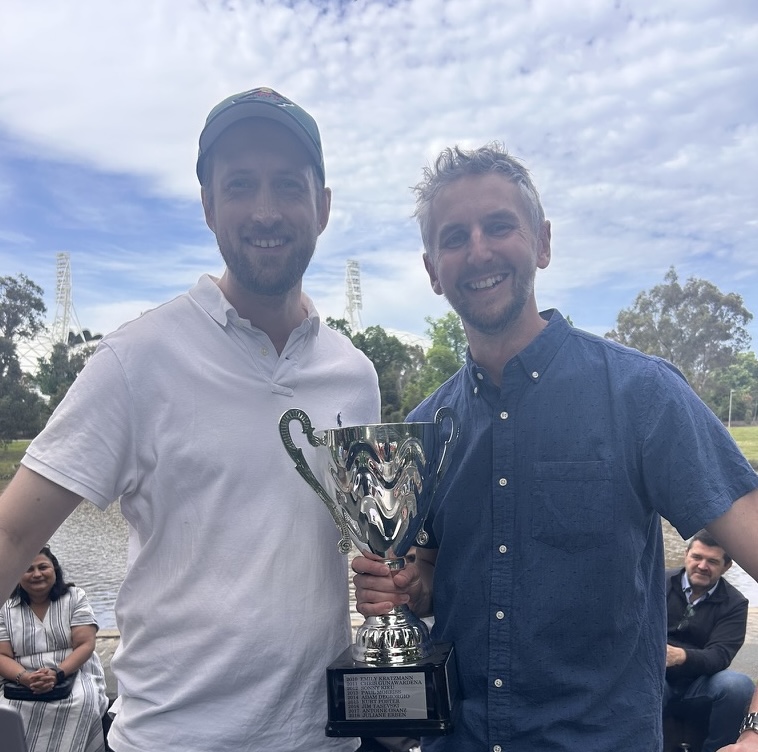 Alan Cole stands next to Antoine Osanz who is holding the Salsa Champion Cup. 